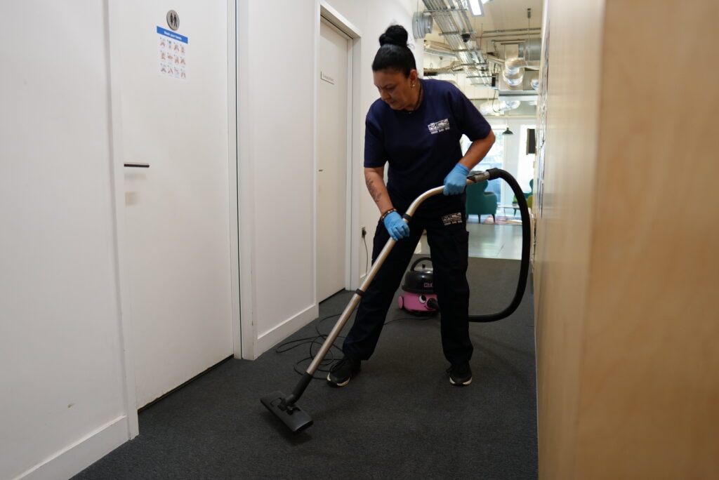 Cleaner mopping a modern office floor – contract cleaning meaning explained